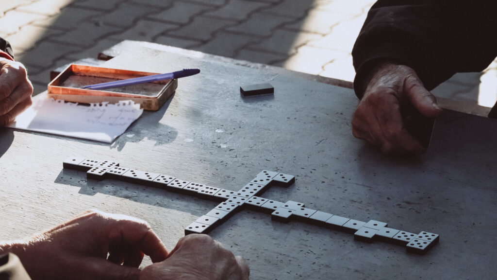 People Playing The Domino Game In The Park