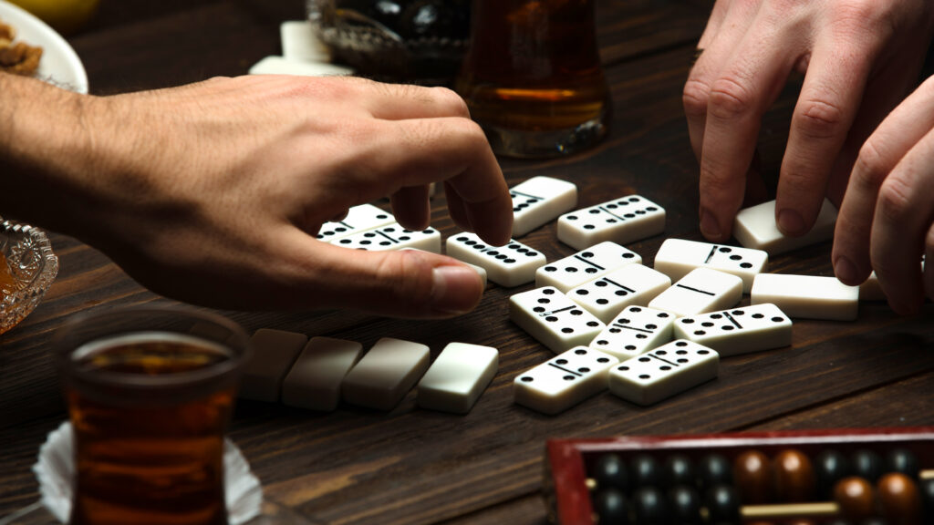 Party Dominoes Over A Cup Of Hot Tea